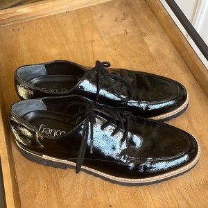 Franco Sarto lace up black patent leather like shoes. Silver lining at the heel.